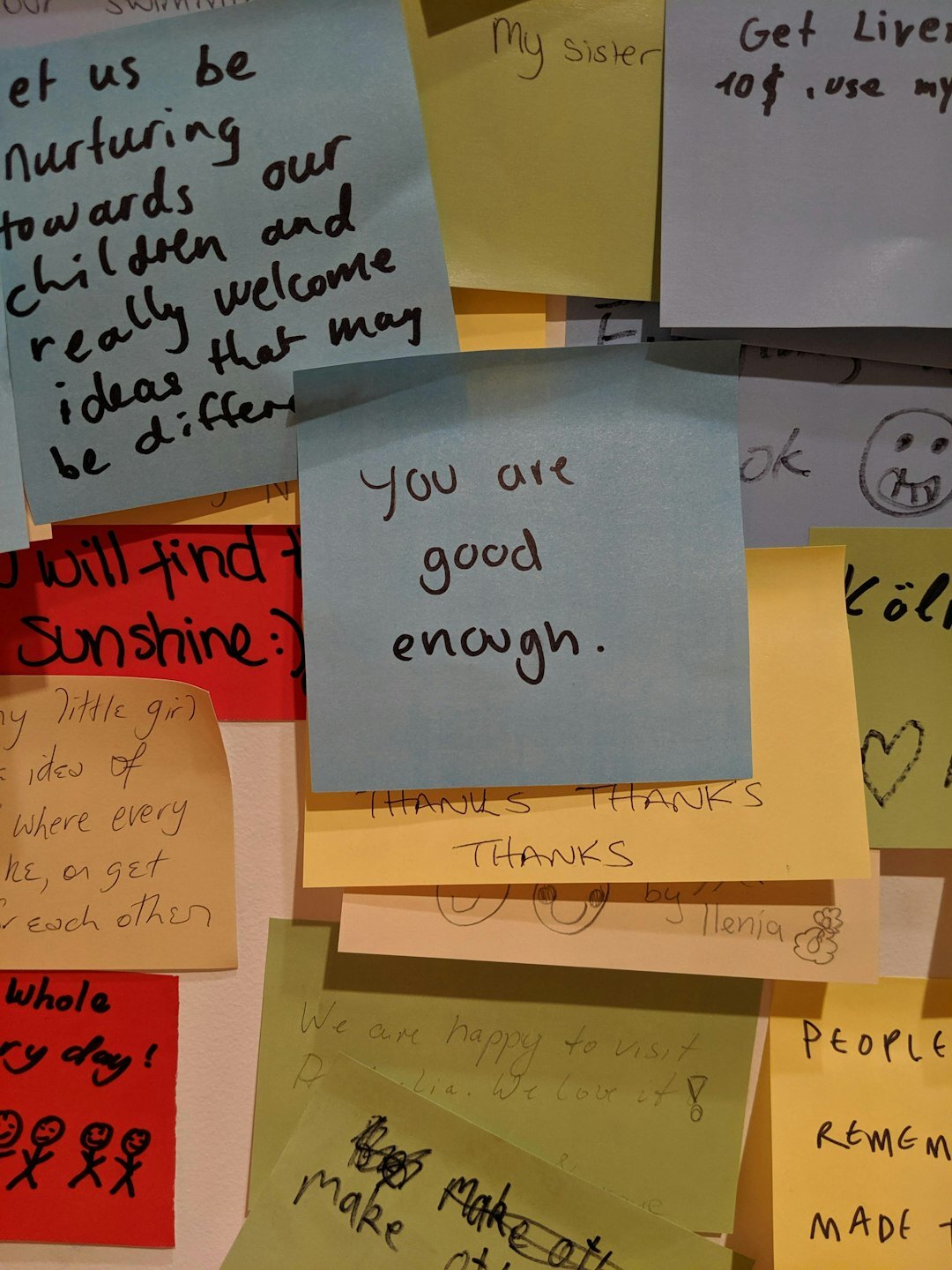 Team brainstorming with sticky notes on a glass wall